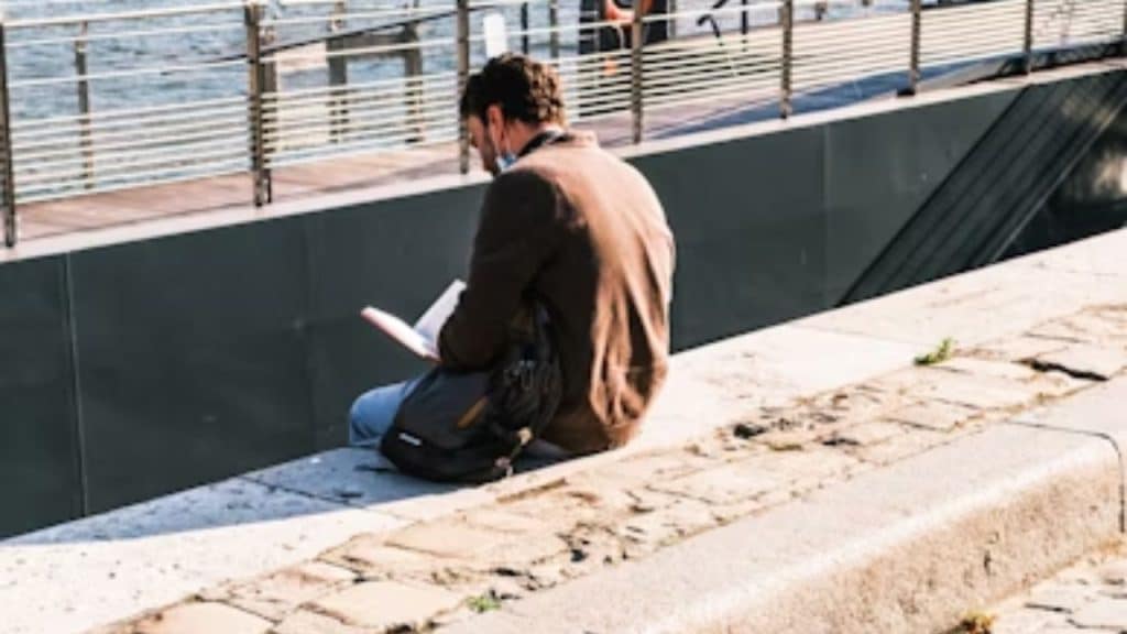 Man journaling or reflecting alone to understand his emotional patterns.