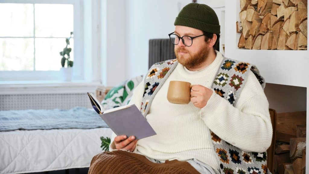 A man having a coffee while reading.