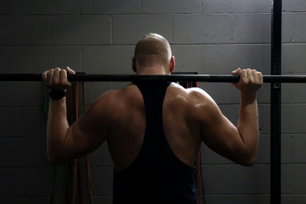 A man lifting a barbell.