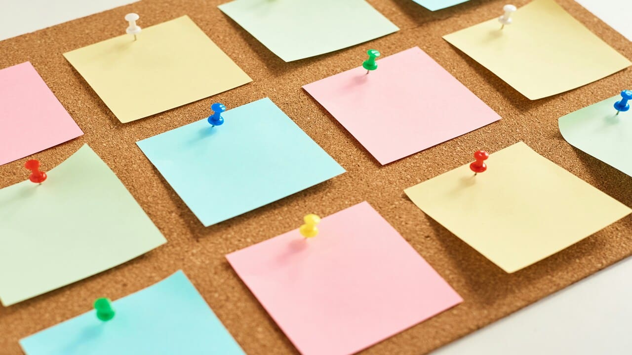 Colored post-its on a cork board.