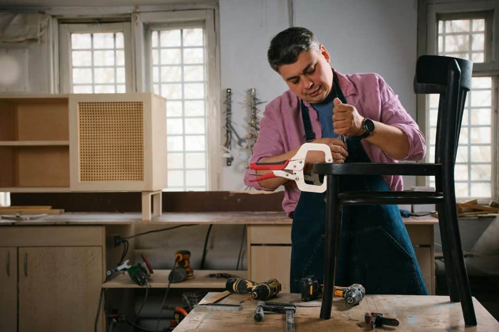 A man fixing their chair.