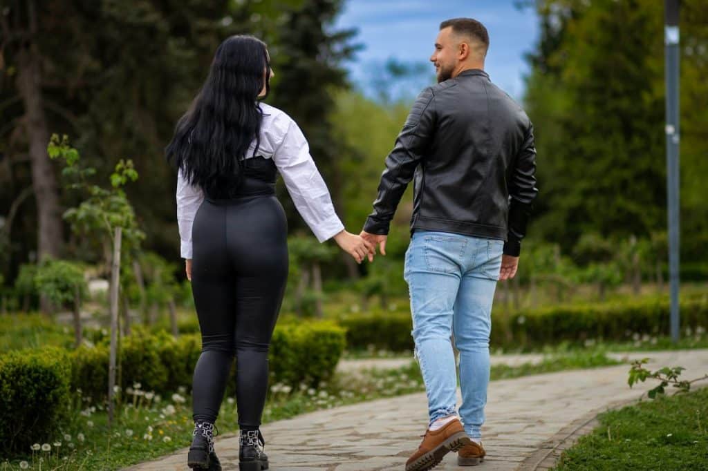 A man and woman walking at the park.