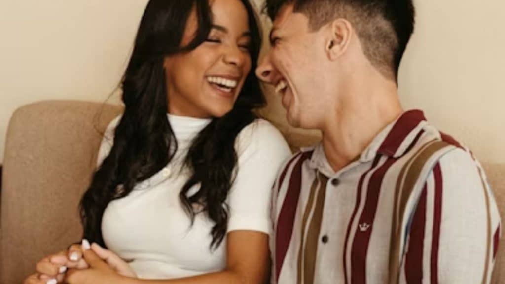 Couple laughing off a minor annoyance together in a lighthearted moment.