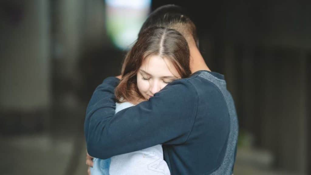 Couple hugging after a disagreement, visibly more connected.