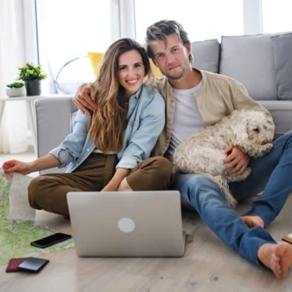 Couple calmly discussing financial goals at home with laptop.
