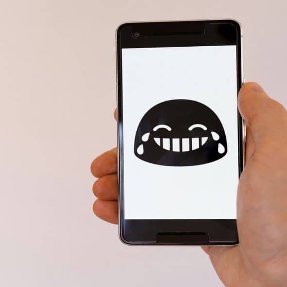 A laughing emoji on a smart phone