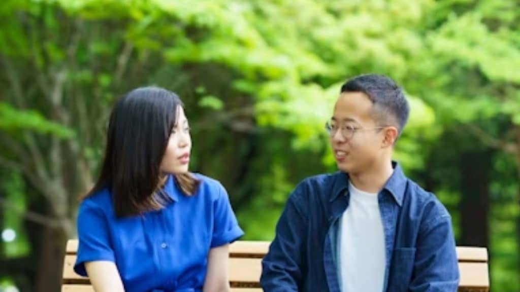 Couple having an open conversation about money while sitting outdoors.