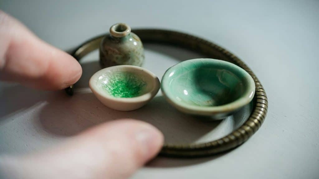 A person playing with small jars