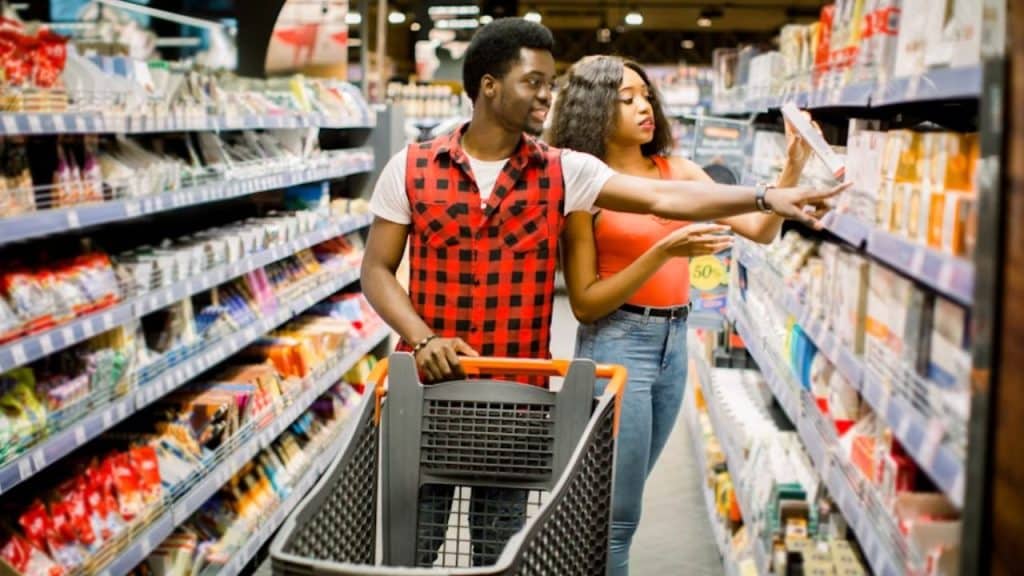 Couple shopping together, comparing price tags.