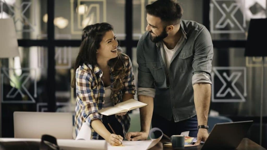 Couple journaling or filling out a relationship quiz together happily