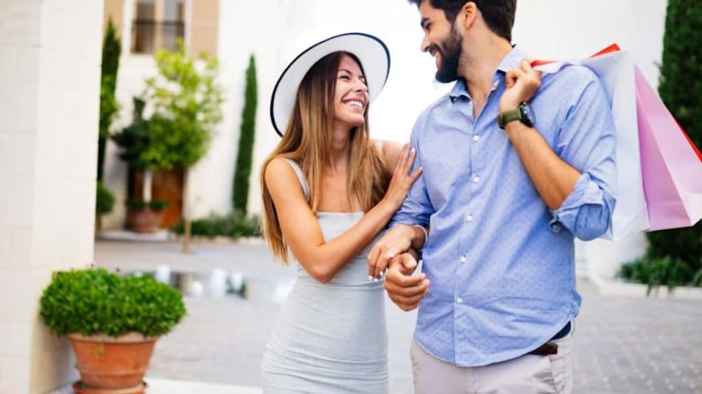 Couple talking while walking outdoors, looking engaged