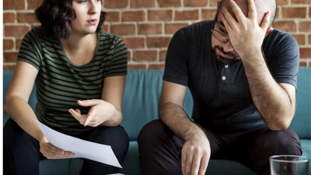 Man discussing financial debt honestly with his partner.
