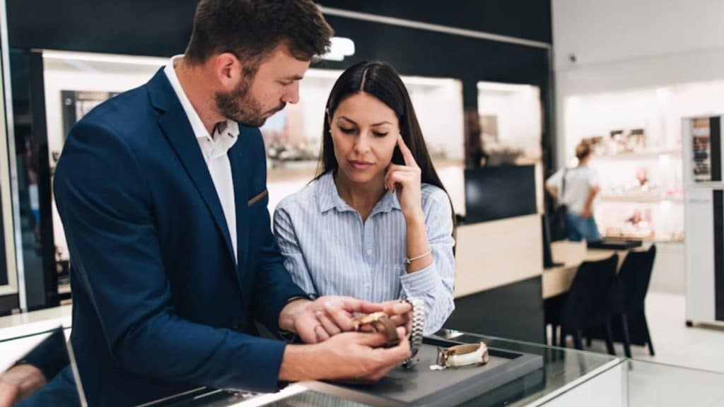 Couple choosing between a luxury item and a practical item in a store.