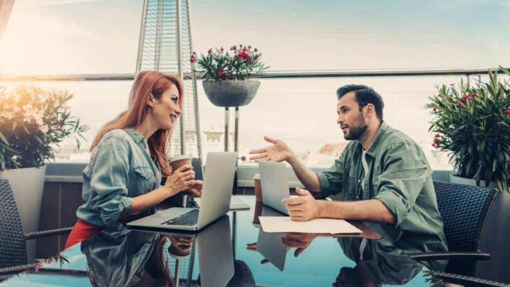 Couple sitting on a rooftop discussing goals over coffee