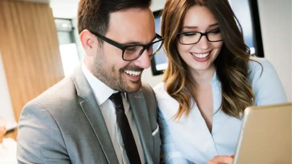 Man and woman working, both expressing confidence and balance