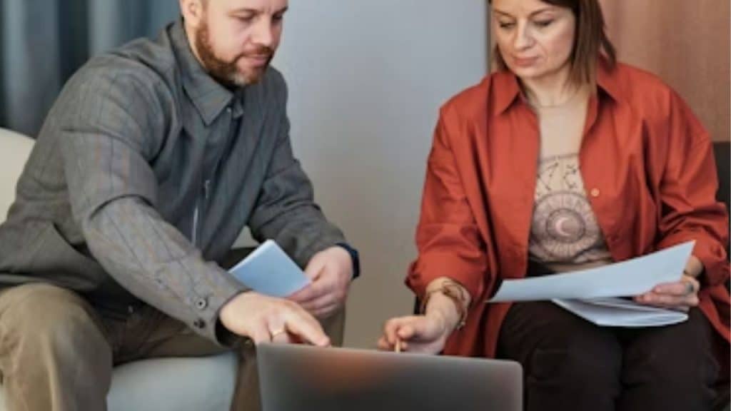Couple casually reviewing finances during a regular weekend meeting.