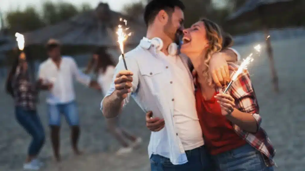 A man and a woman enjoying the party at the beach without insecurities