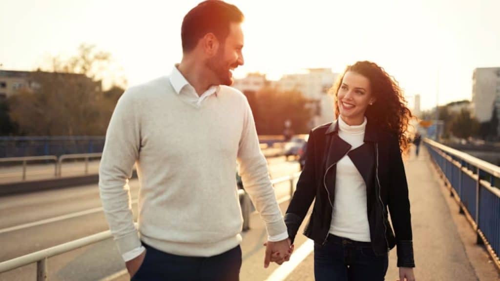 Couple walking confidently together, representing partnership and financial trust.