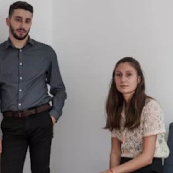 Couple looking frustrated but thoughtful in a modern apartment.