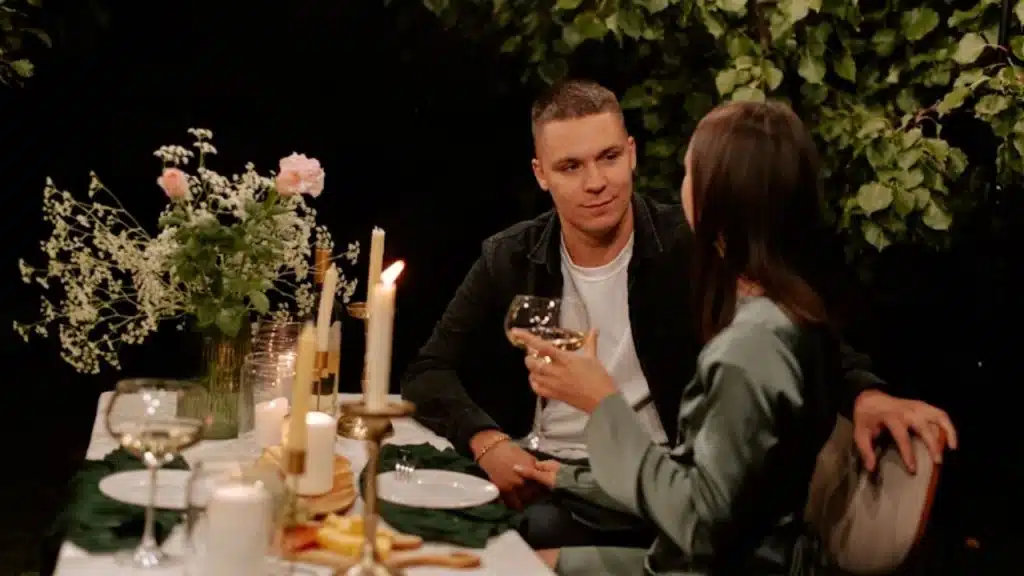 Man feeling sincere in apologizing to his partner during dinner.