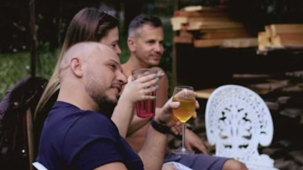 Man watching his partner from a distance with a concerned look.