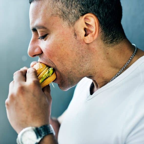 A man eating a burger.
