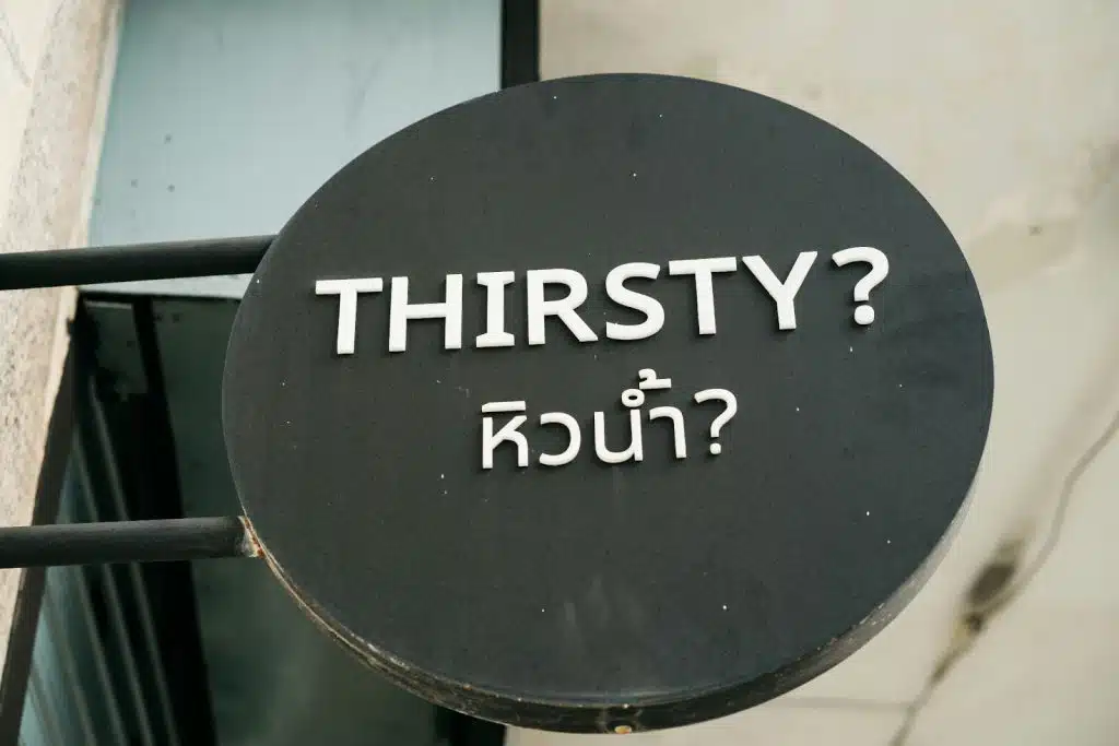 A picture of a sign that says โthirsty?โ.