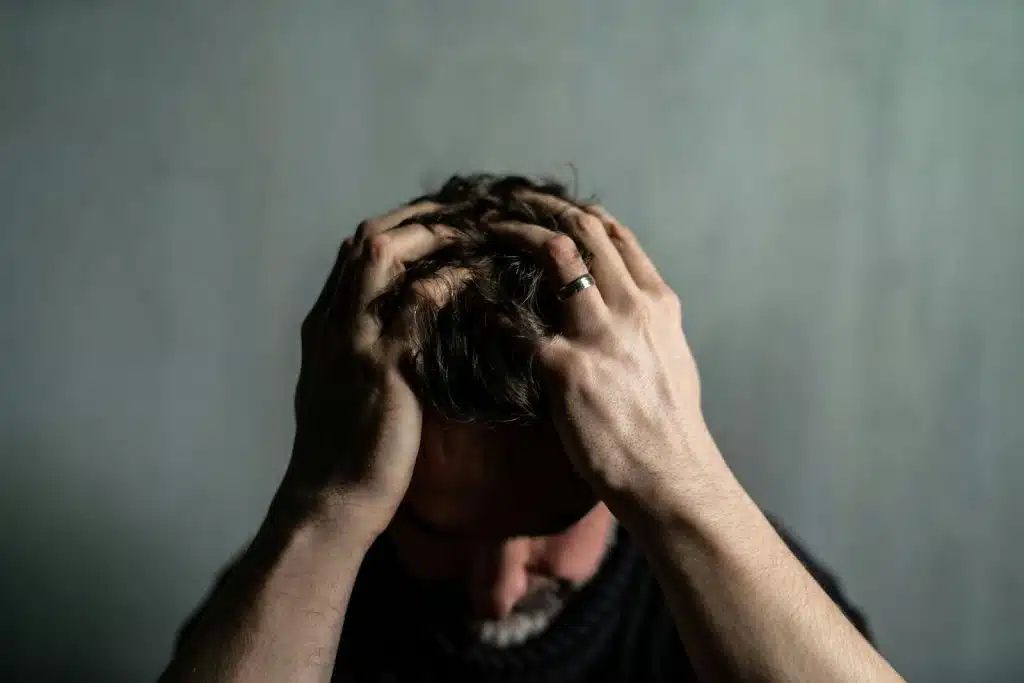 A man sitting alone at the dark room.