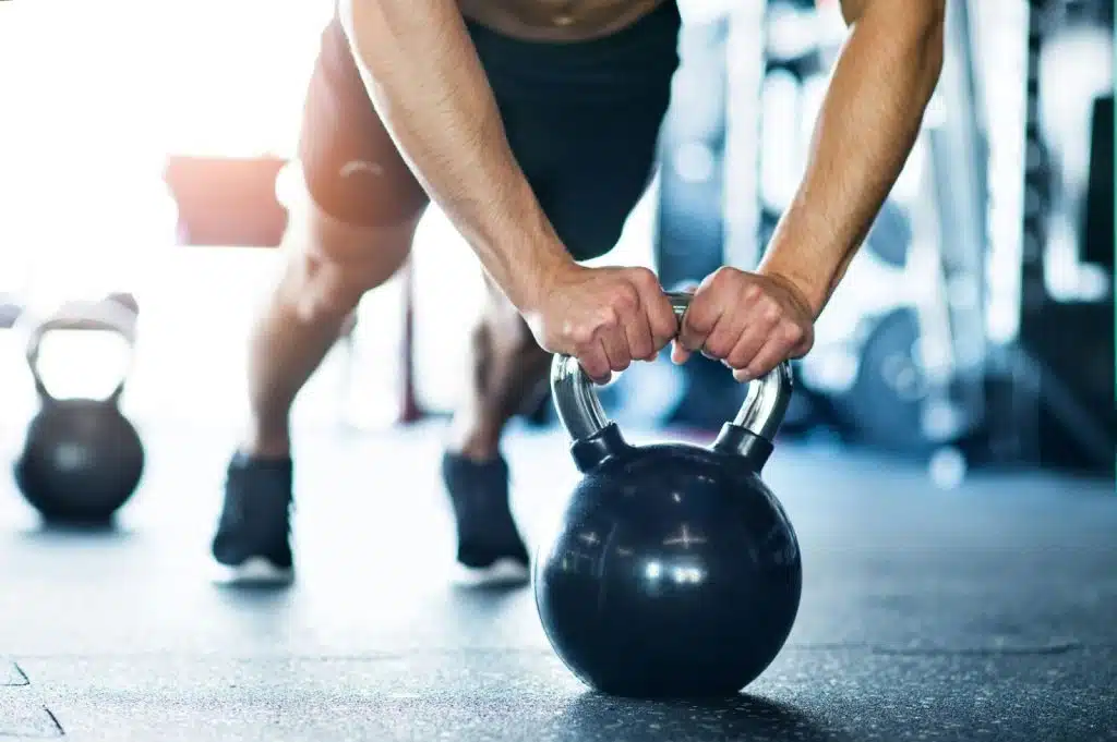 A man using a kettlebell.