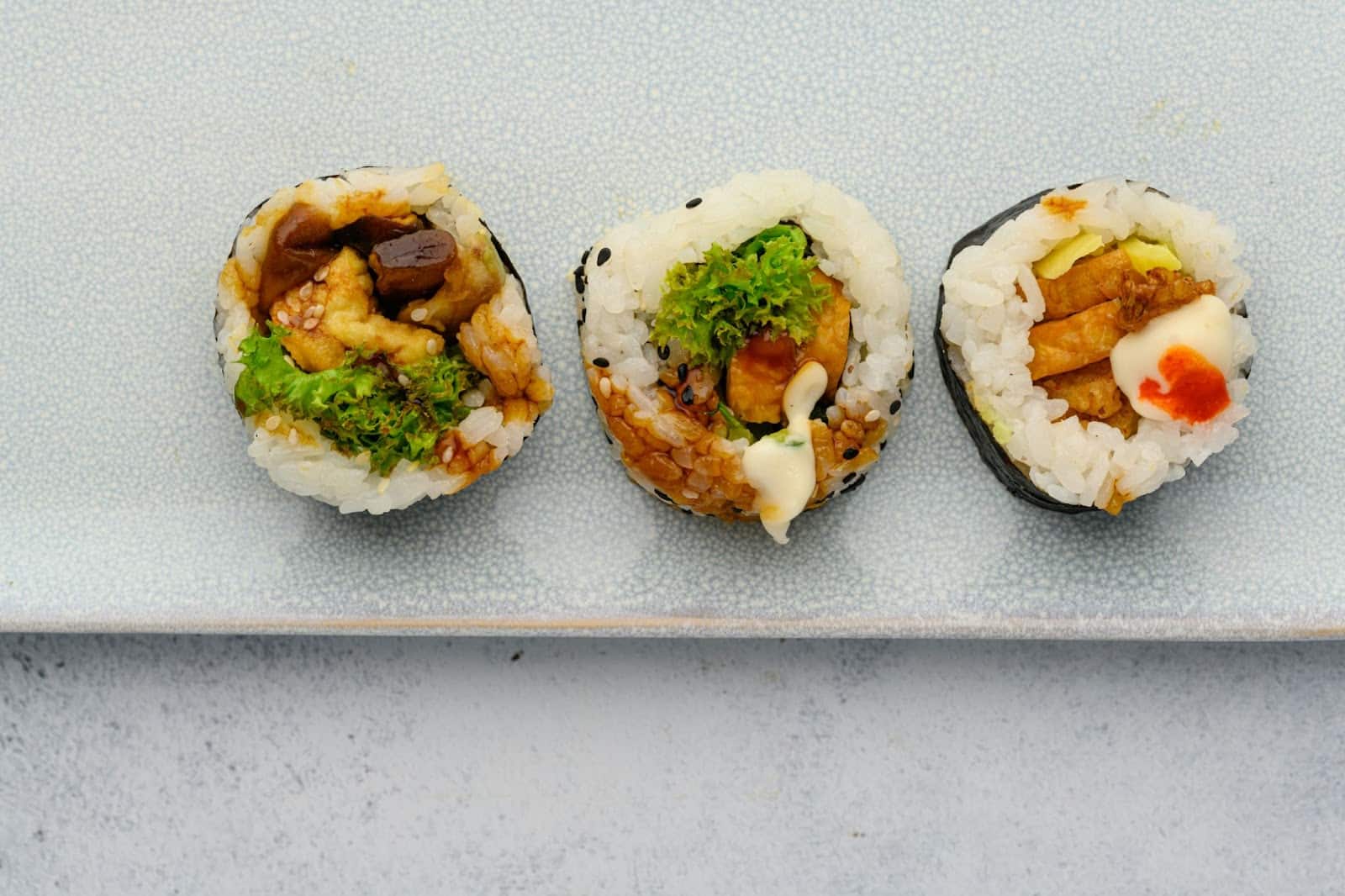 A picture of three different sushi.