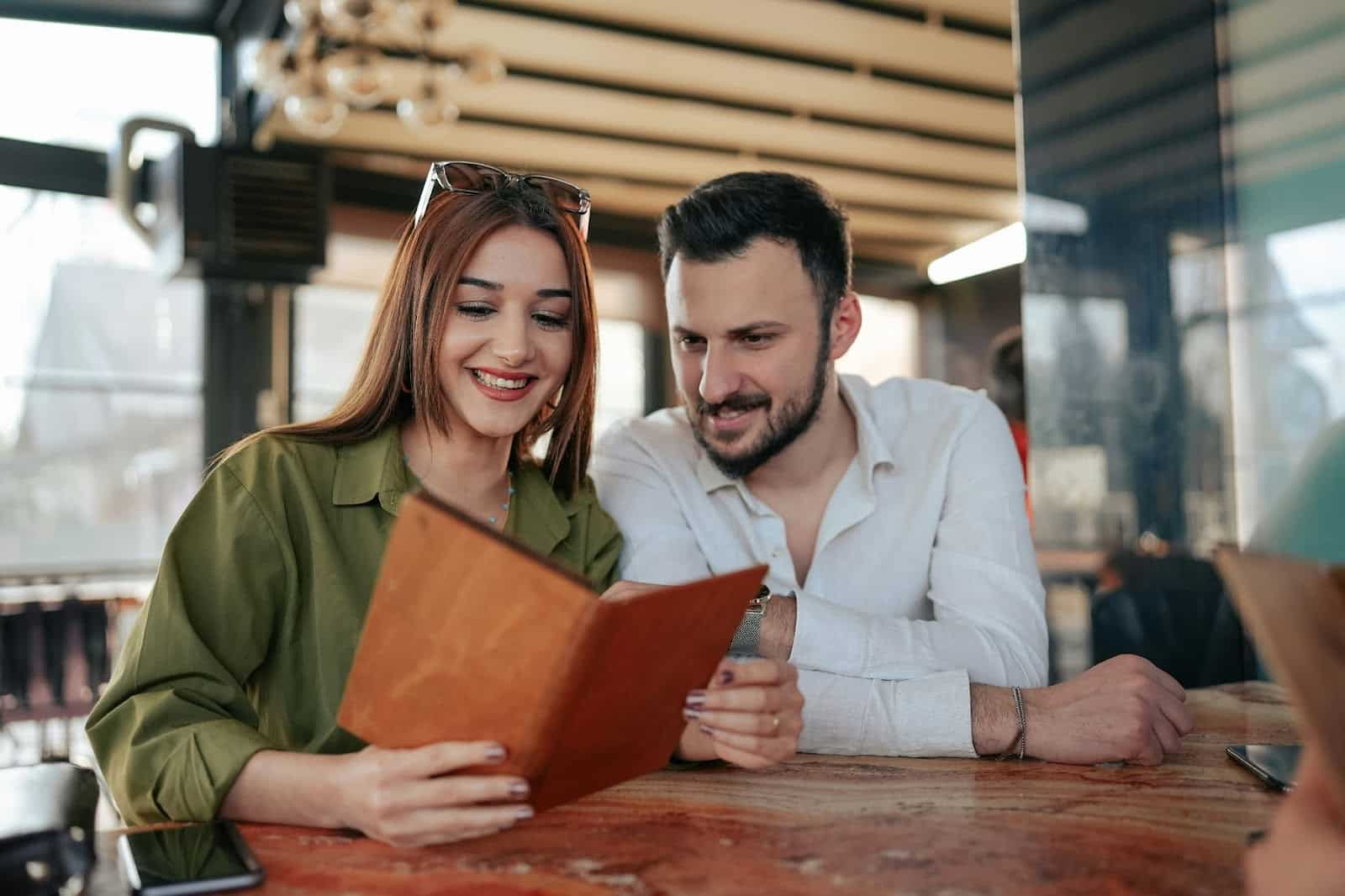 A man and woman looking at the menu.