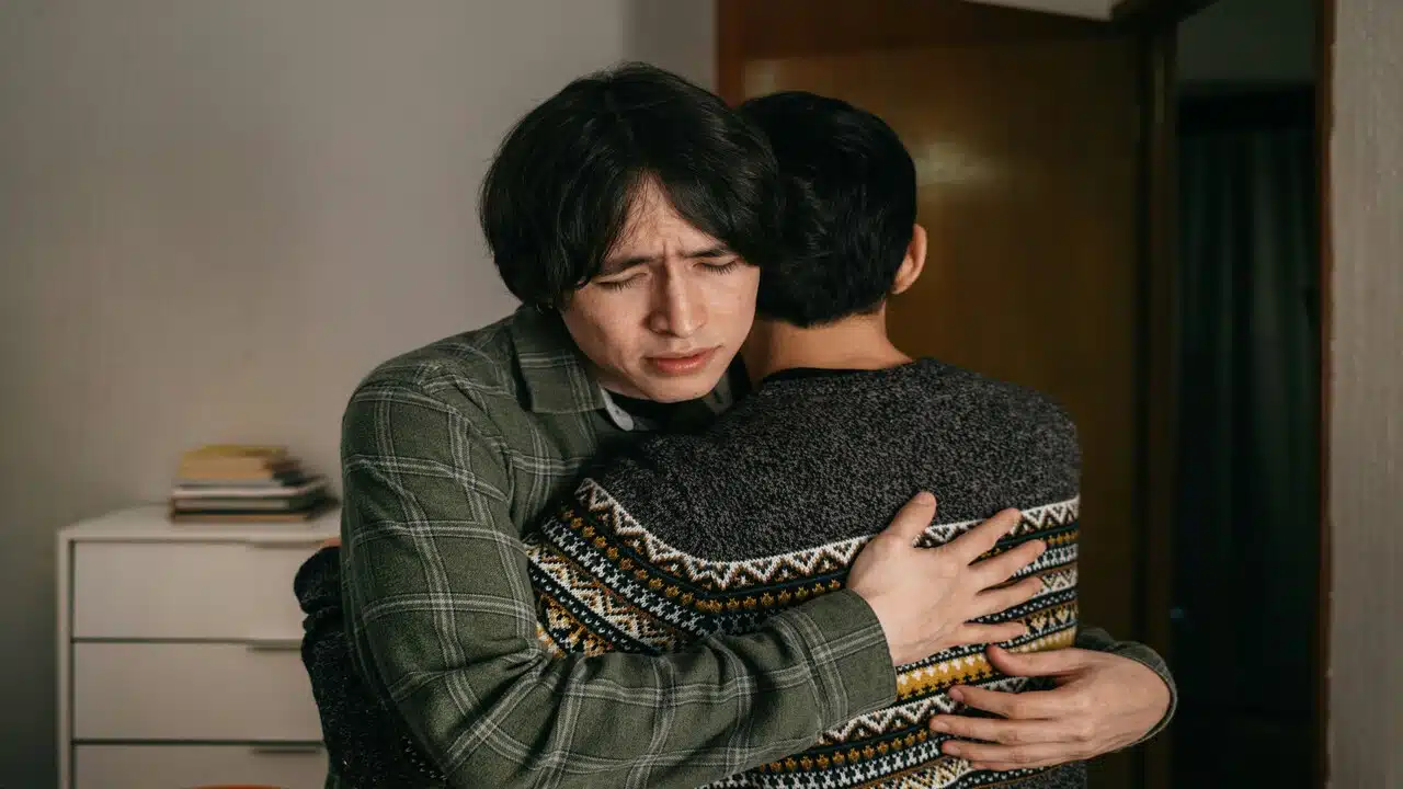 A couple hugging at home.