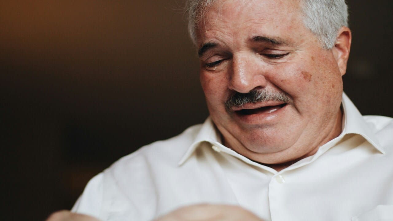 A close up of a man crying.