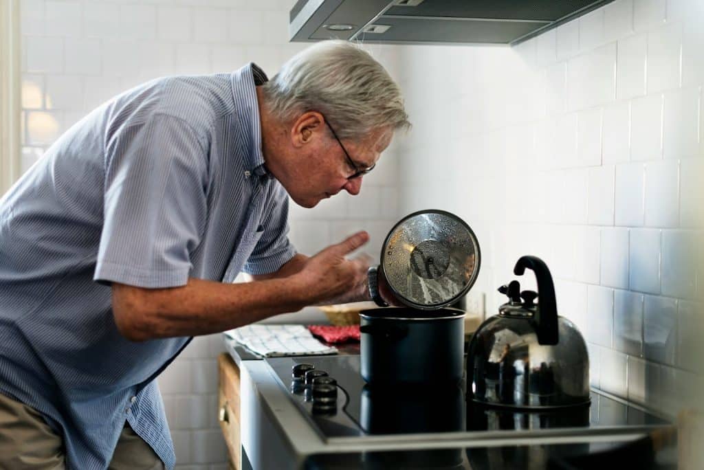 A smelling the dish he cooked.