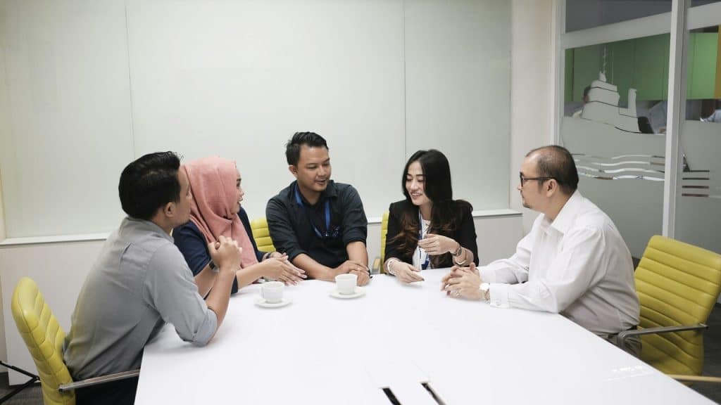 A group of colleagues talking at work