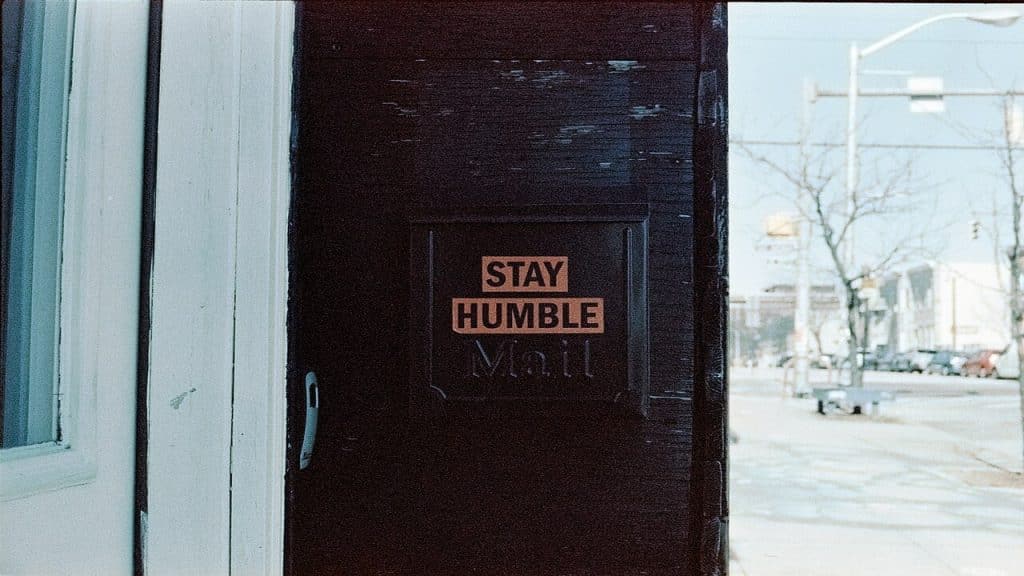 A door sign that says “stay humble