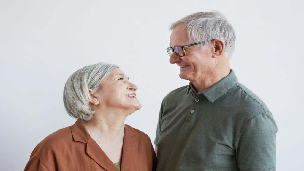 An older couple smiling at each other