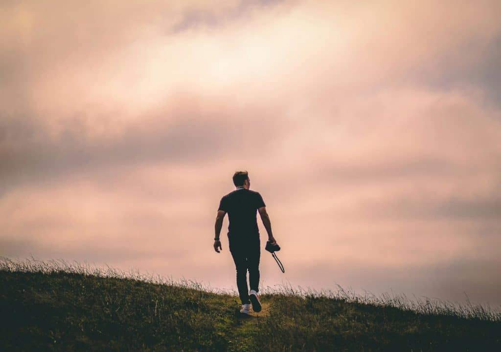 A man walking on a grassfield.