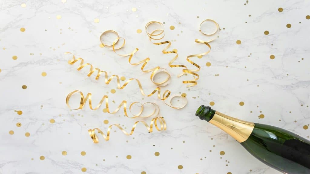Gold streamers coming out of champagne bottle 