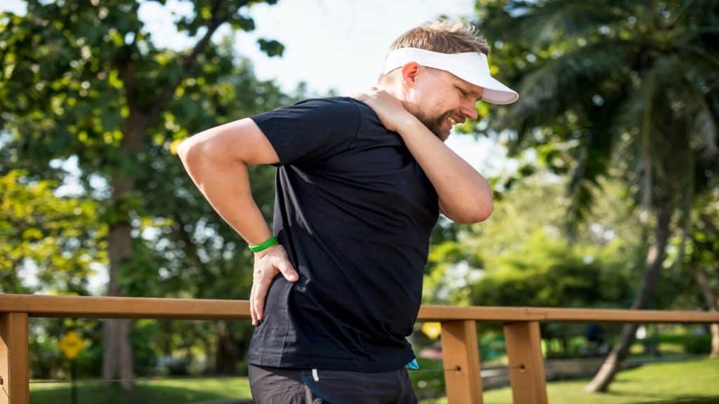 A man having back pain while running