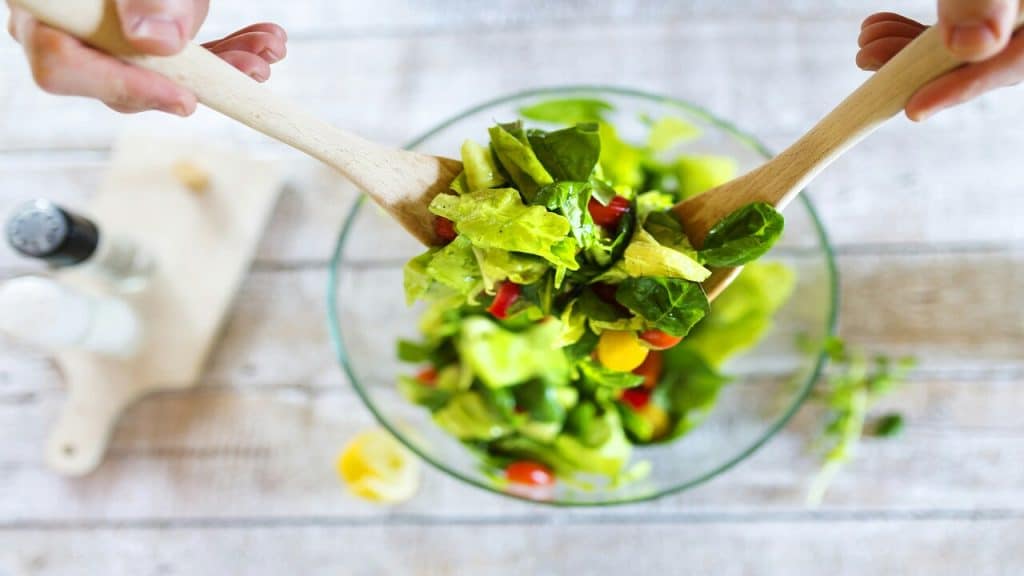 A person preparing a salad
