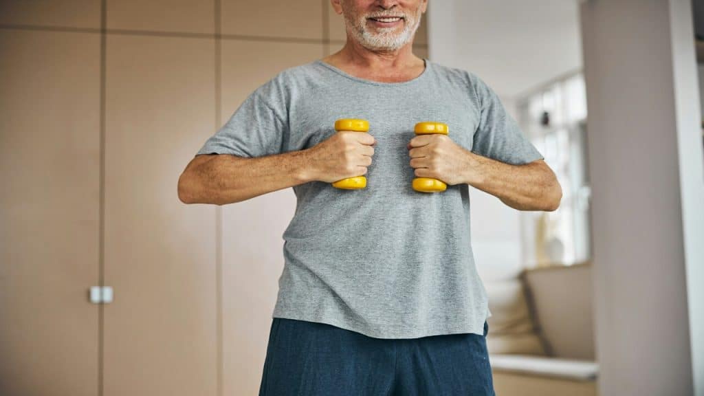 A man holding a pair of dumbbells