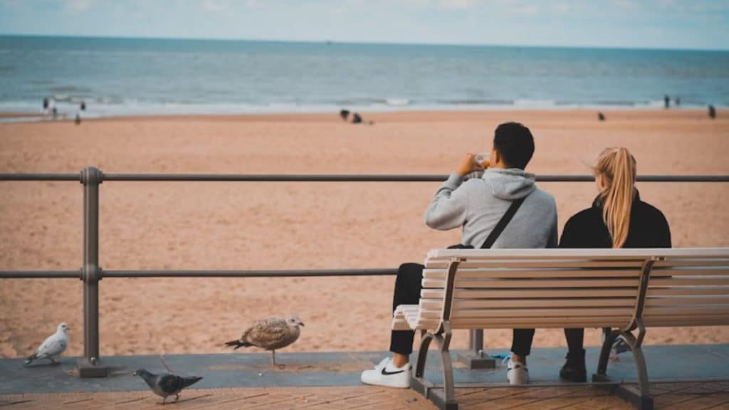 Couple at the beach navigating timing together while staying emotionally present