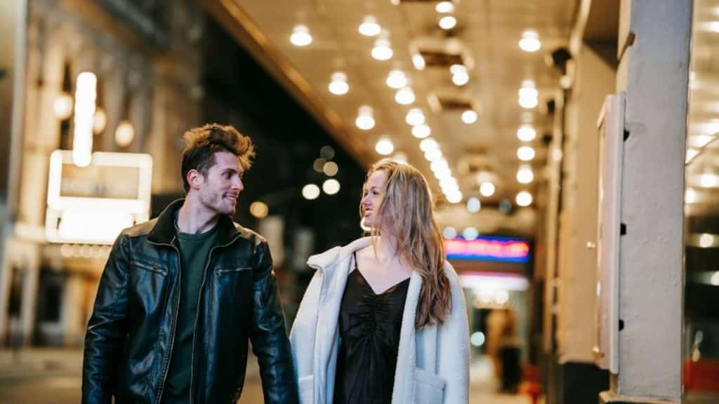 Couple walking side by side, both confidently leading