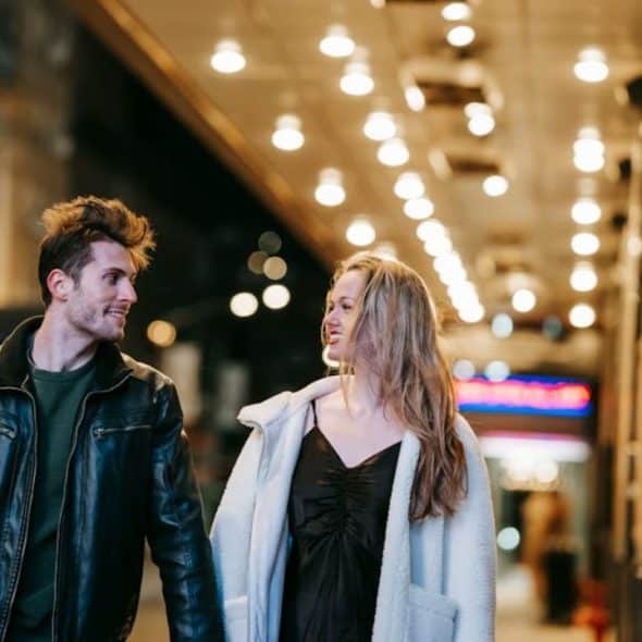 Couple walking side by side, both confidently leading