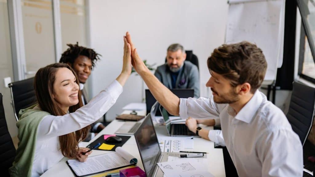 Man doing high five but feeling with a woman