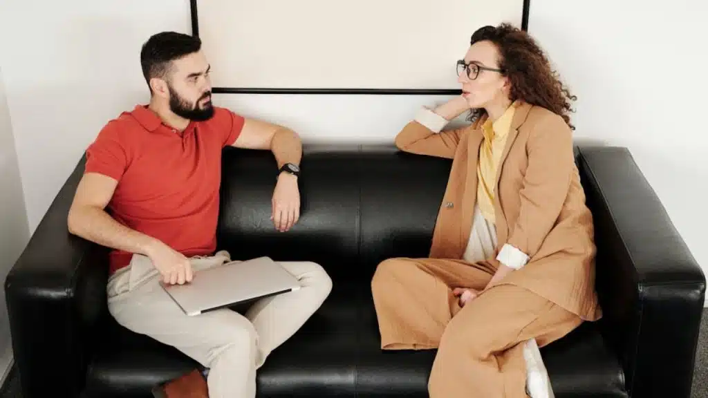Woman speaking calmly while man listens with care