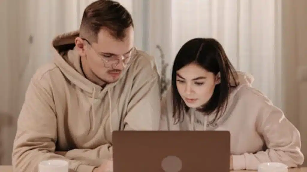 Couple planning together with a laptop in front of them