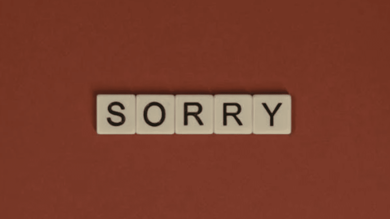 Scrabble tiles spelling out “sorry”.