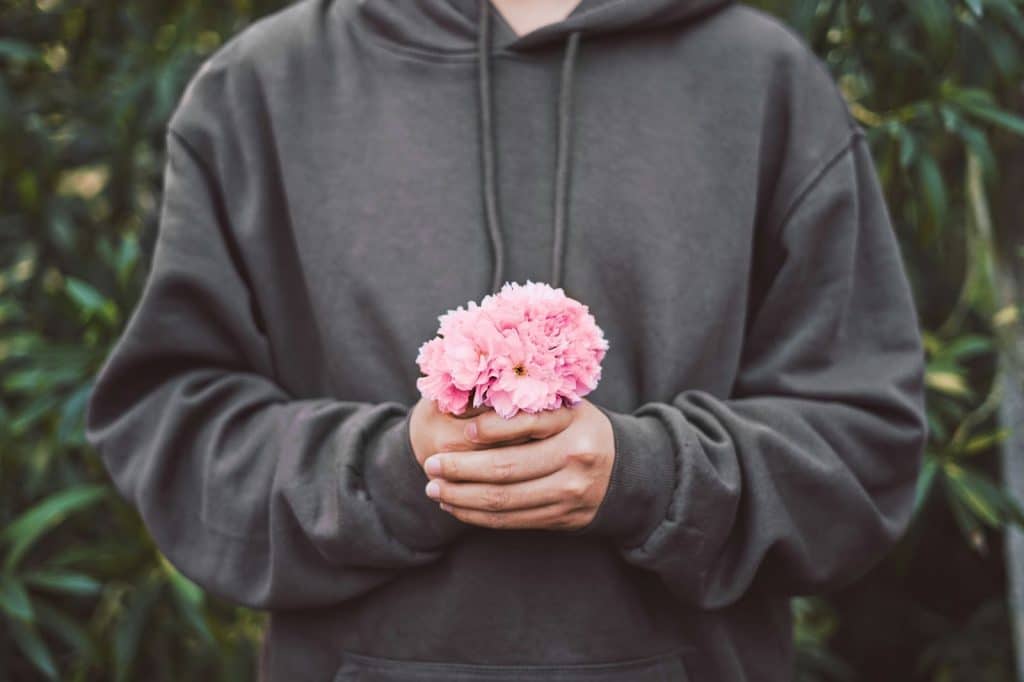 A man holding a flower 
